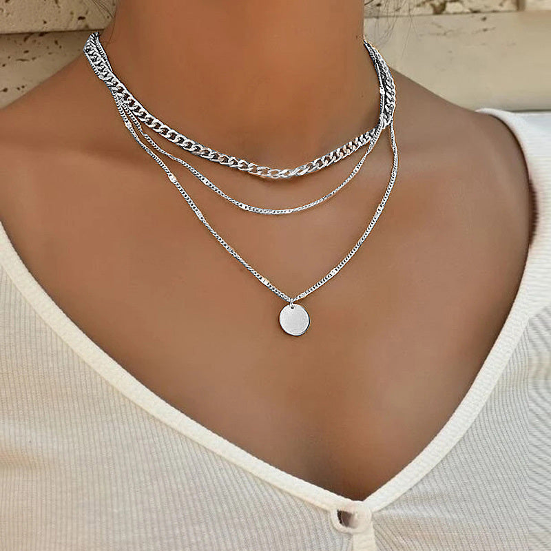 Trendy clavicle-length layered necklace crafted with alloy chains and polished pendants.