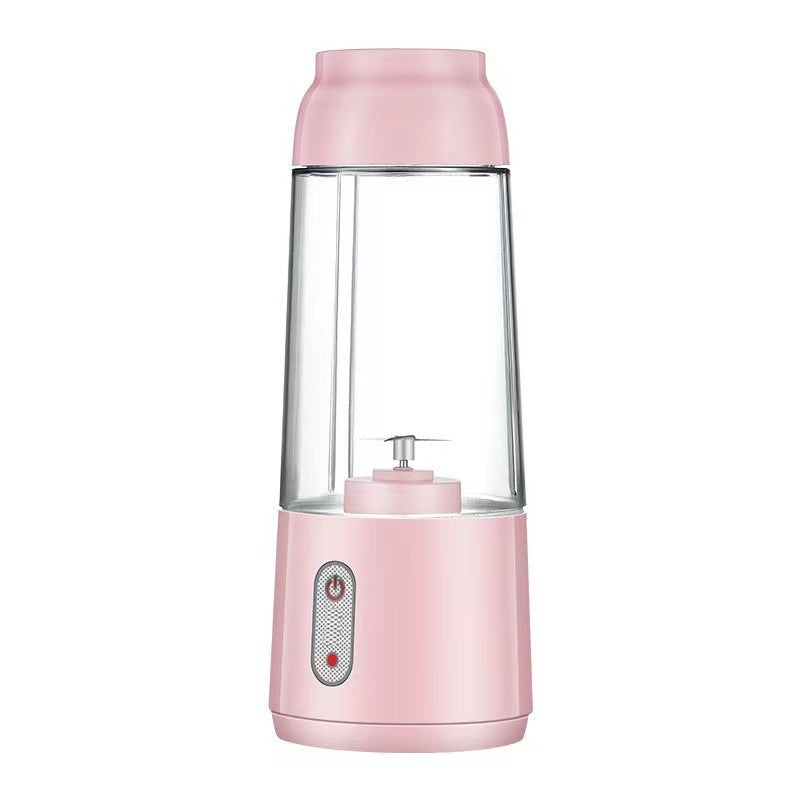 Small household smoothie blender blending fruits in the cup.