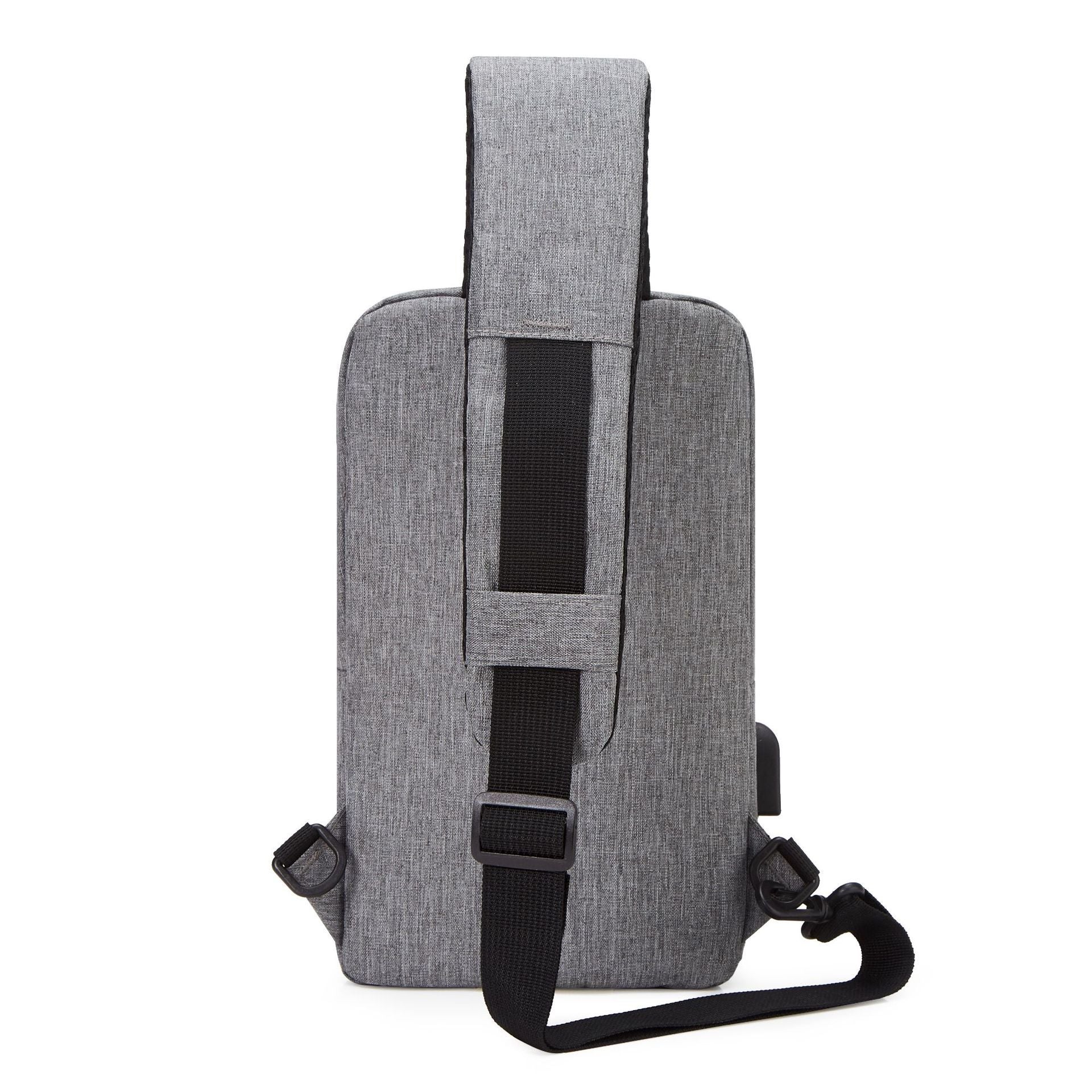 A grey sling bag is shown from the back, featuring a black strap and a visible USB charging port.
