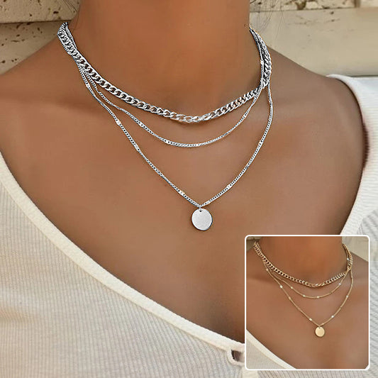 Elegant multilayer clavicle necklace with round disc pendants in gold finish.
